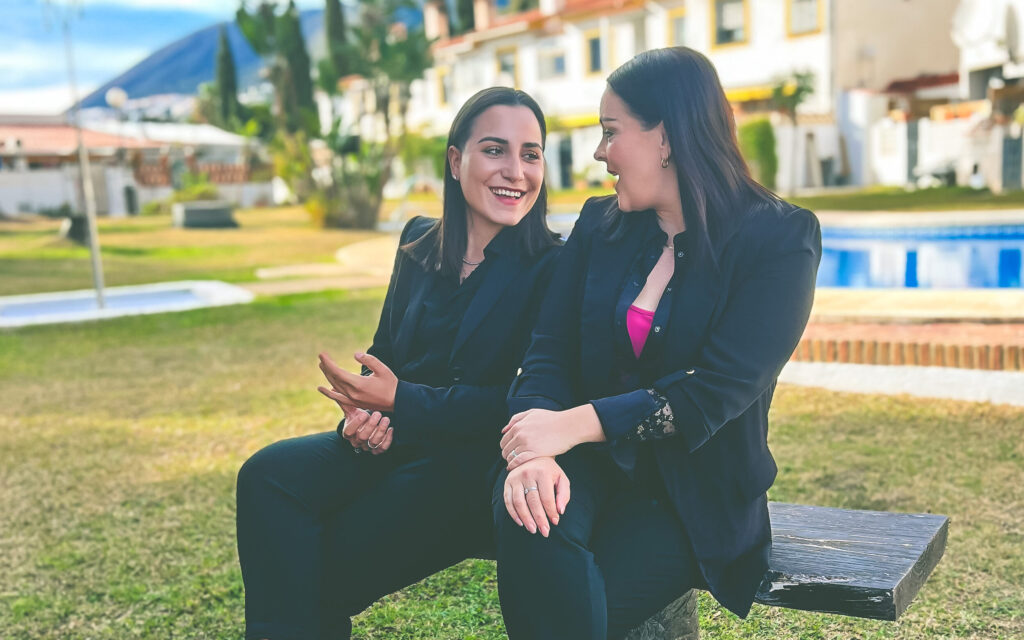 Laura and Raja from La Raya Spanish Properties sitting in a Marbella garden discussing the real estate market in Marbella. Discover the Finest Luxury Properties for Sale in Marbella with us.